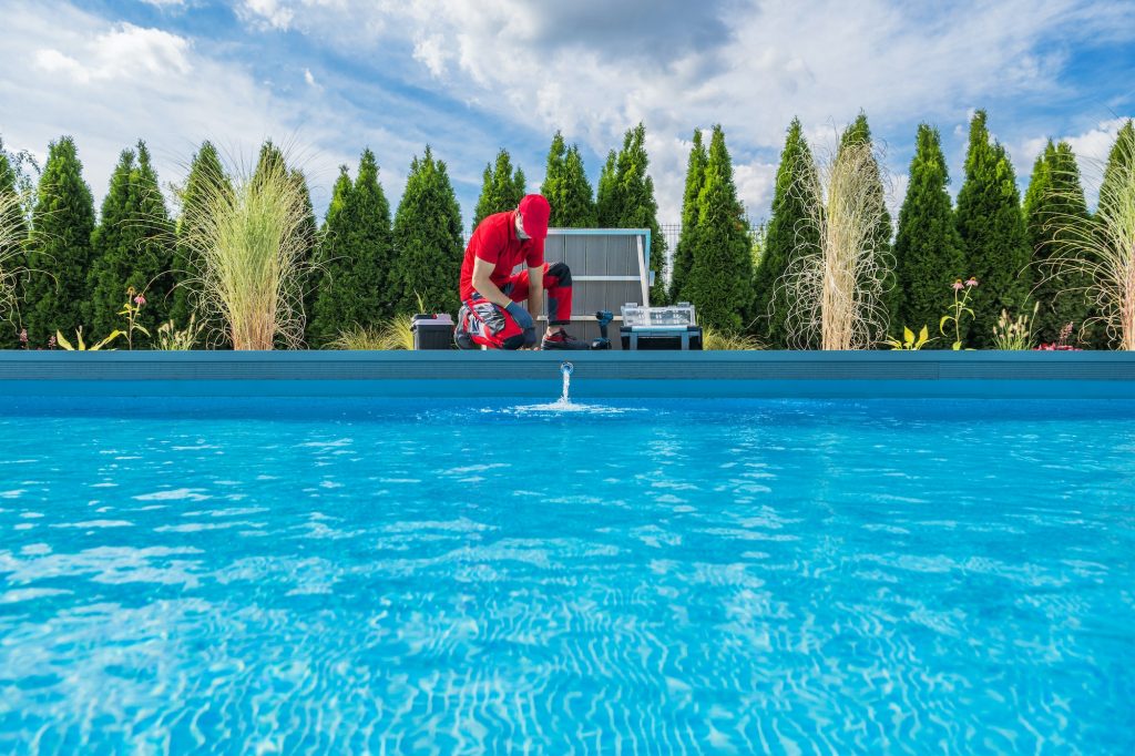 Professional Swimming Pools Technician Performing Seasonal Maintenance